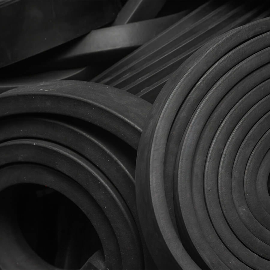 Coiled black rubber sheets used in industrial sealing