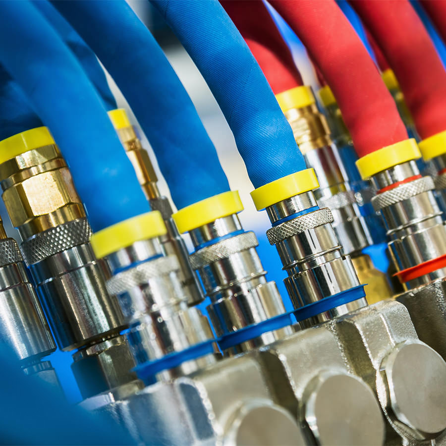 Close-up of hydraulic hoses with color-coded fittings
