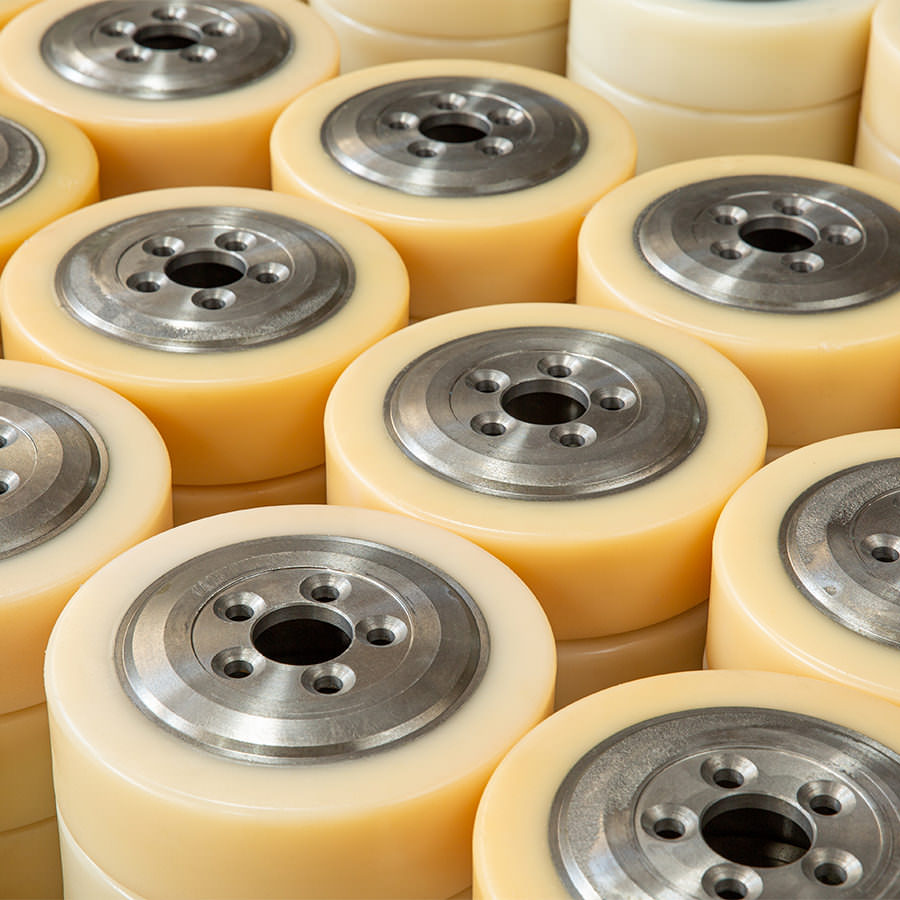 Heavy-duty polyurethane rollers with metal cores for industrial machinery.