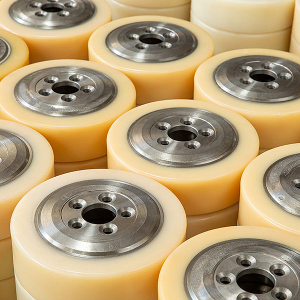 Heavy-duty polyurethane rollers with metal cores for industrial machinery.